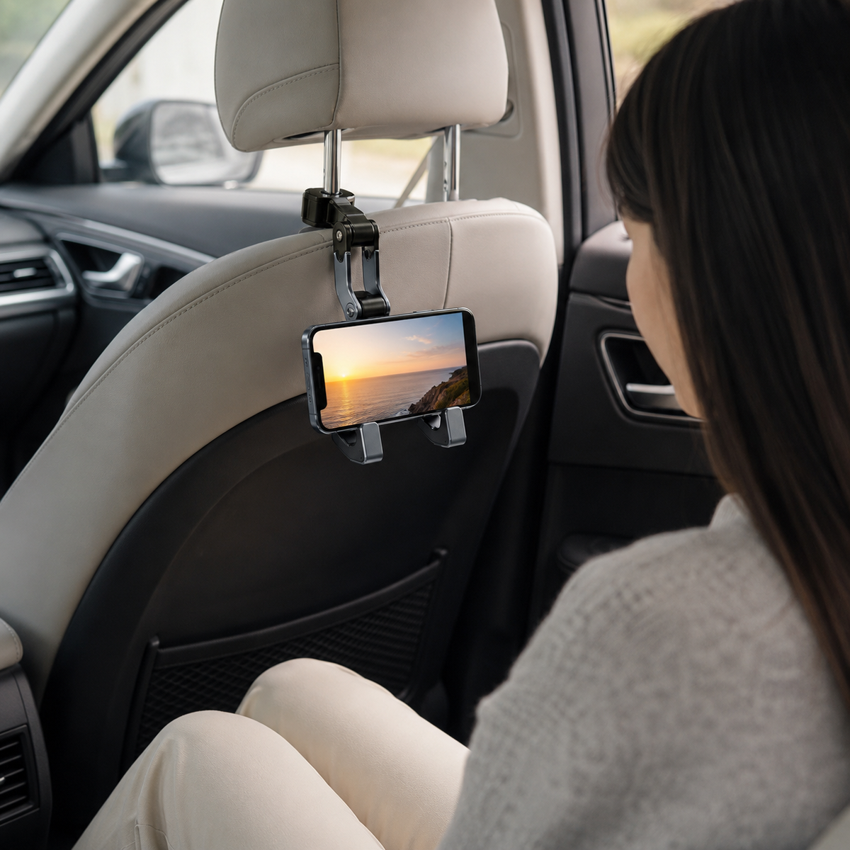 Rear passenger viewing a phone securely mounted to an exposed car headrest post