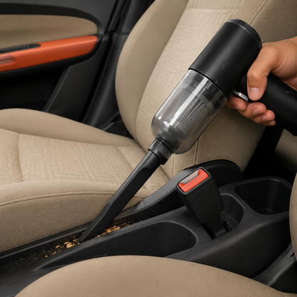 Portable car vacuum cleaning crumbs beside the centre console